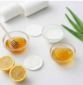 Person applying a mixture of honey and lemon juice under the eyes for dark circles treatment.